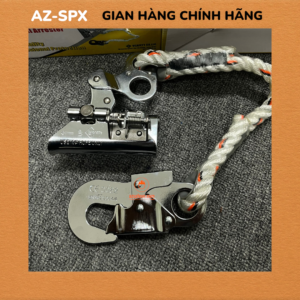 Climbing safety hardware featuring a locking carabiner and rope pulley on braided white rope with orange threads, laid on a dark surface.